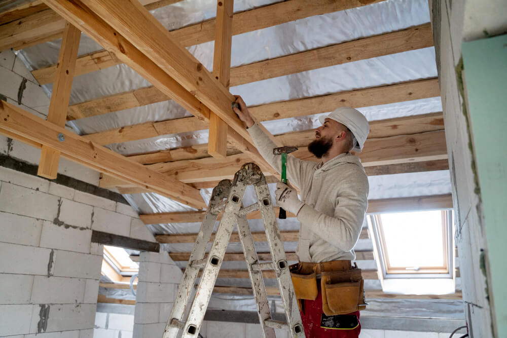 Close teamwork fitting ridge detail on a standing-seam roof