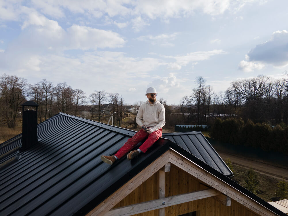 Finished slate roof with terracotta ridge tiles and chimney detail